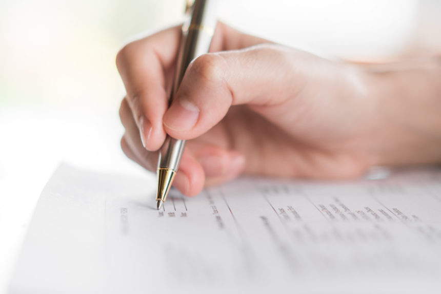 hand-with-pen-application-form hand-with-pen-application-form