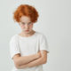 isolated-portrait-unhappy-little-kid-with-red-curly-hair-freckles-being-offended