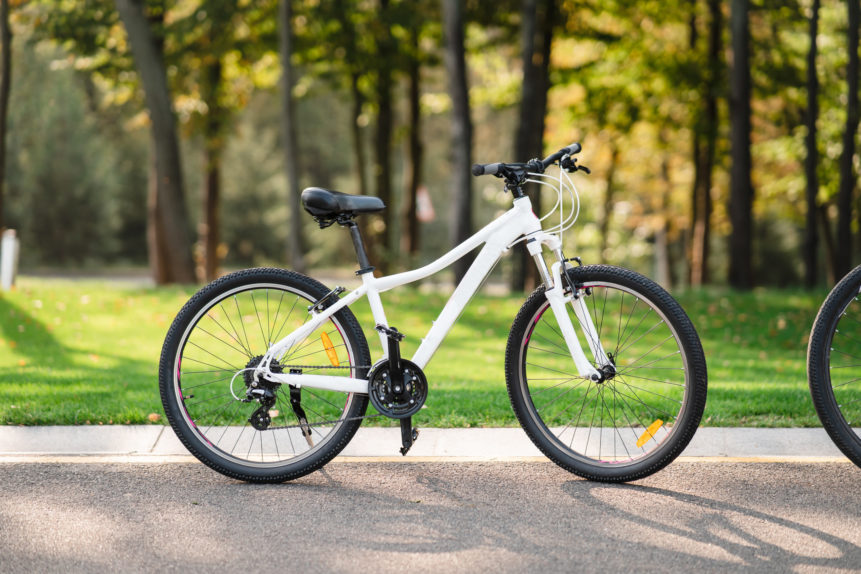 white-bicycle-standing-park