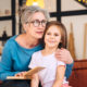 nice-elderly-woman-grandmother-reading-story-granddaughter