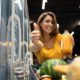 female-person-holding-orange-juice-in-grocery-store-and-showing-thumbs-up_342744-1135