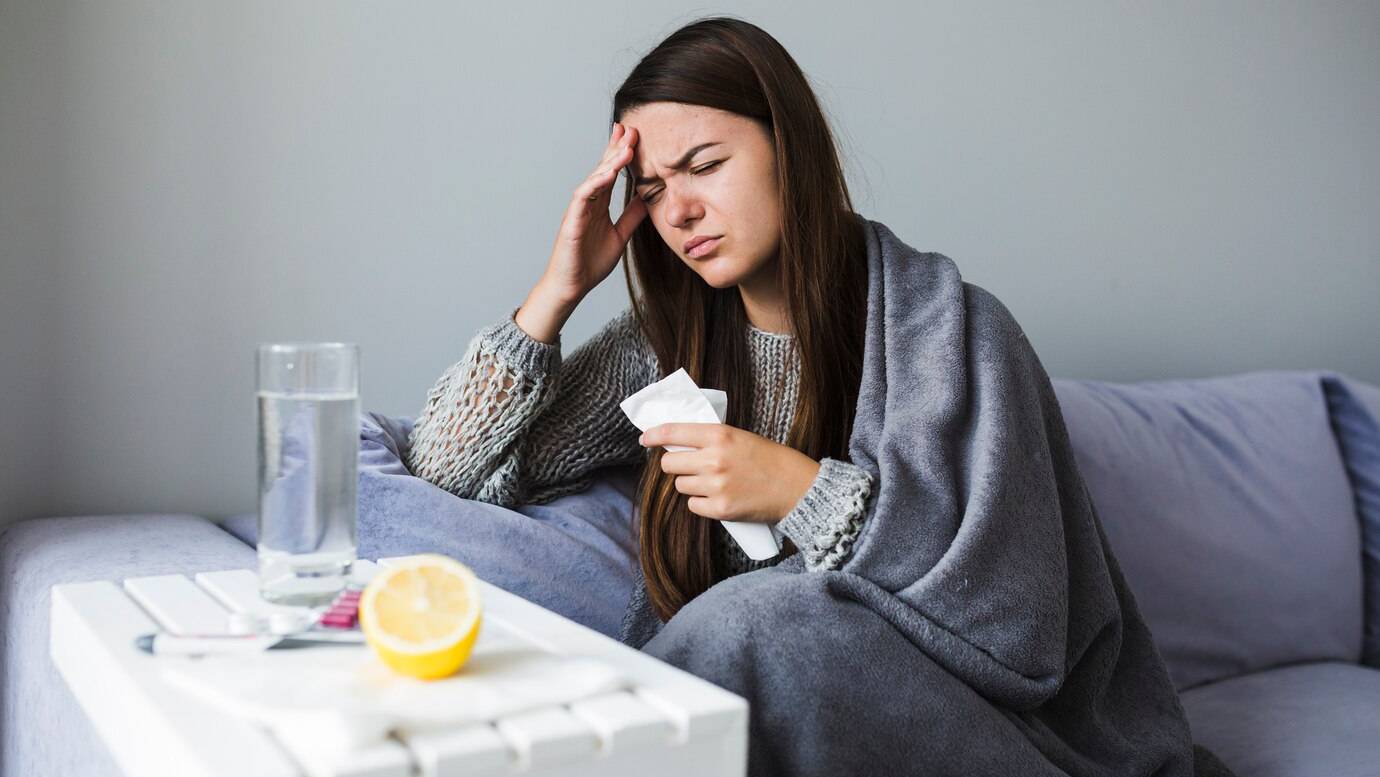 woman-on-couch-with-medication_23-2147934385