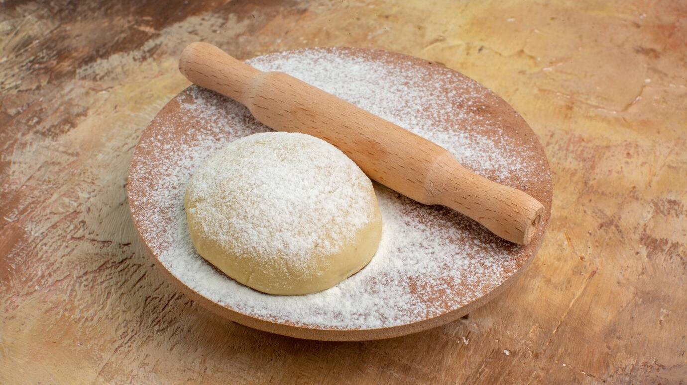 front-view-raw-dough-slice-with-flour-on-a-cream-desk-dish-cuisine-pasta_140725-89549