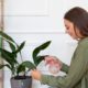 medium-shot-woman-watering-leaf_23-2149099005
