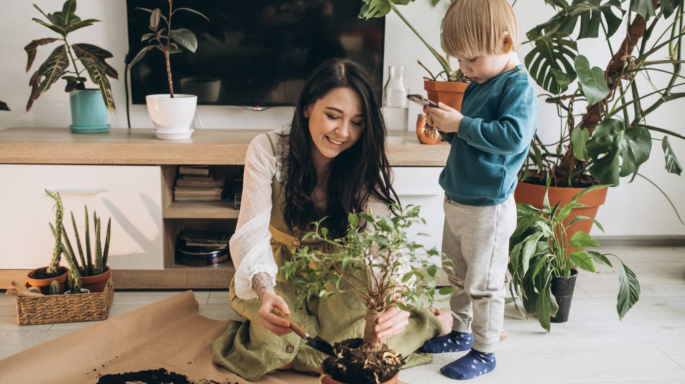 mother-with-little-son-cultivating-plants-at-home_1303-22939