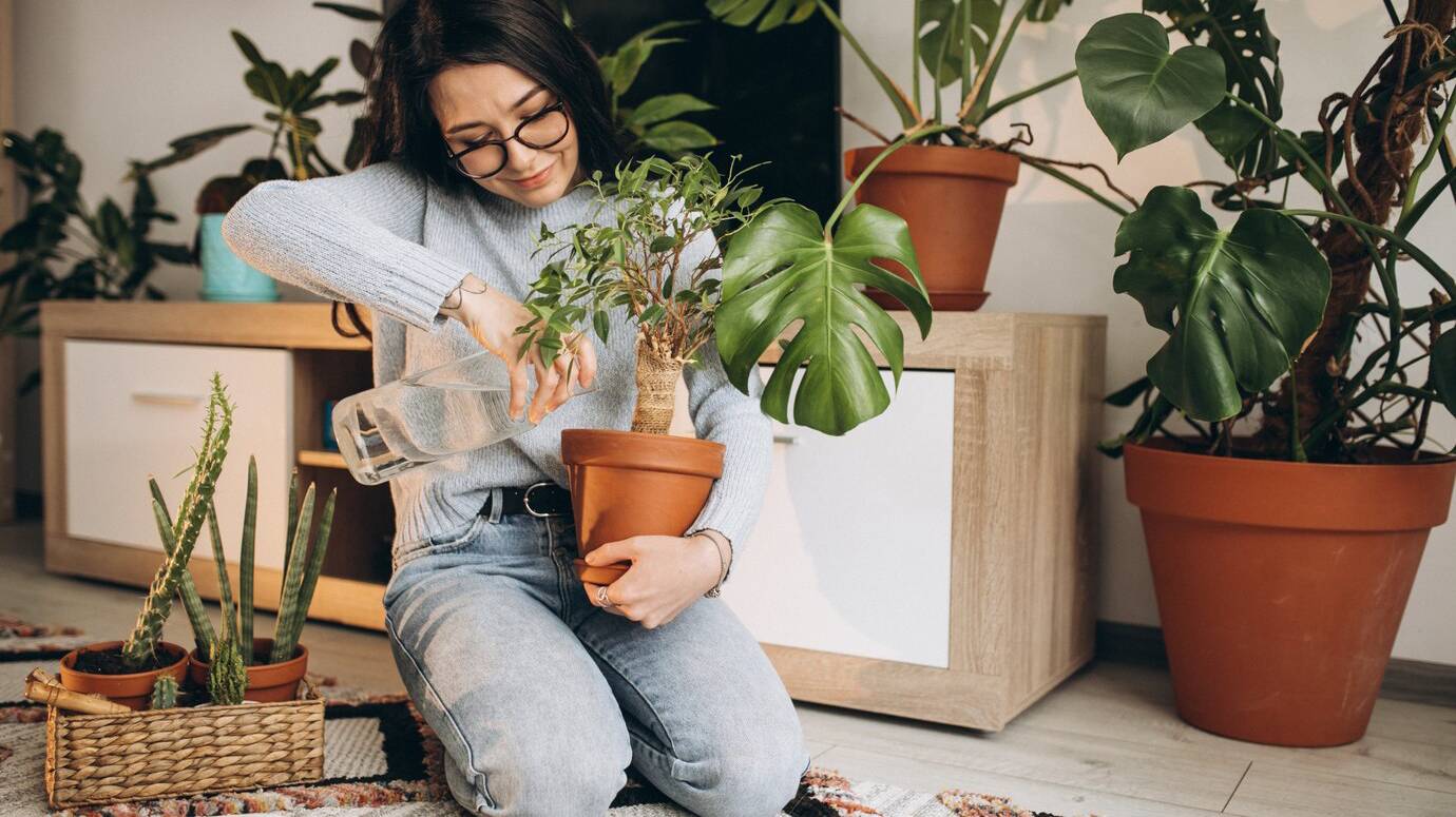 young-woman-cultivating-plants-at-home_1303-22937