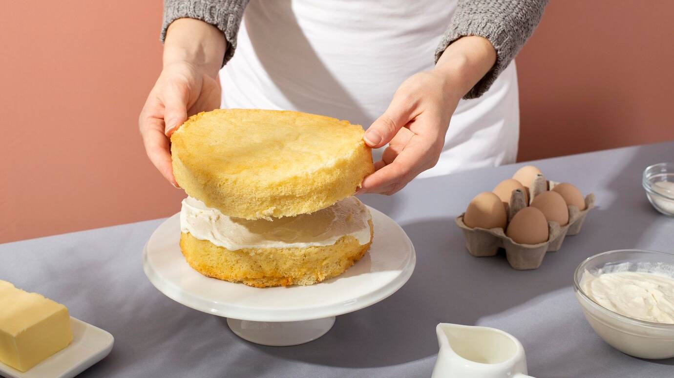 close-up-hands-making-cake_23-2149144128