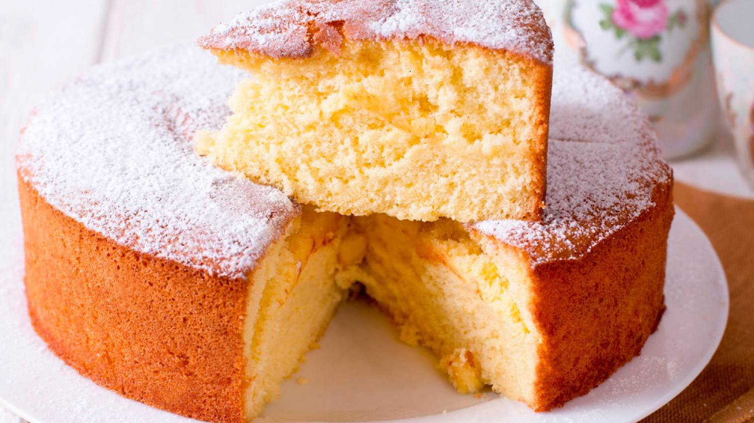 stock-photo-homemade-sponge-cake-on-a-white-wooden-table-1139612393