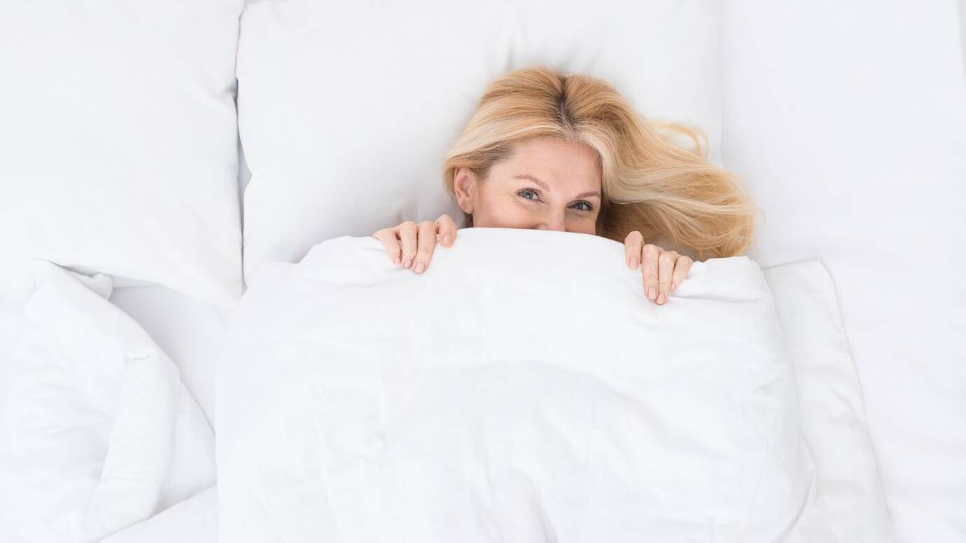 top-view-lovely-senior-woman-in-bed_23-2148440180