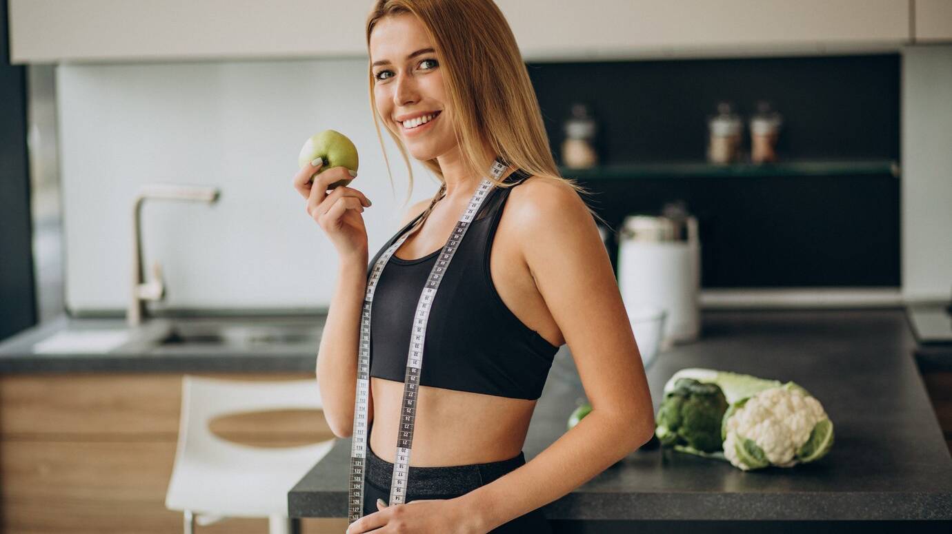 young-woman-with-measuting-tape-kitchen_1303-24764