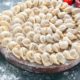 front-view-little-raw-dumplings-with-flour-vegetables-dark-surface_179666-44095 (1)