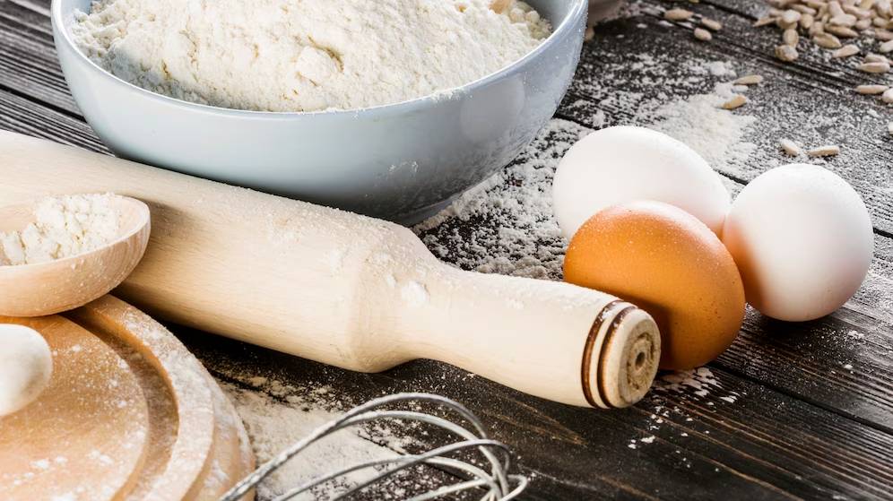 white-flour-with-eggs-kitchen-table_23-2147872734