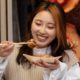 young-adult-enjoying-japanese-street-food_23-2149319429