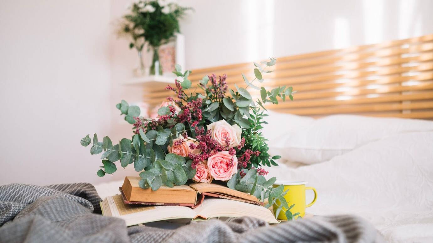bouquet-lying-books_23-2147711724