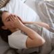 high-angle-anxious-woman-laying-bed_23-2149450353