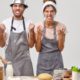 husband-wife-pose-kitchen-preparing-tasty-dinner_273609-35637