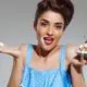 portrait-beautiful-pin-up-woman-eating-cake_176420-3341