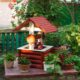 stock-photo-small-garden-backyard-fake-well-with-potted-flowers_132075-5927