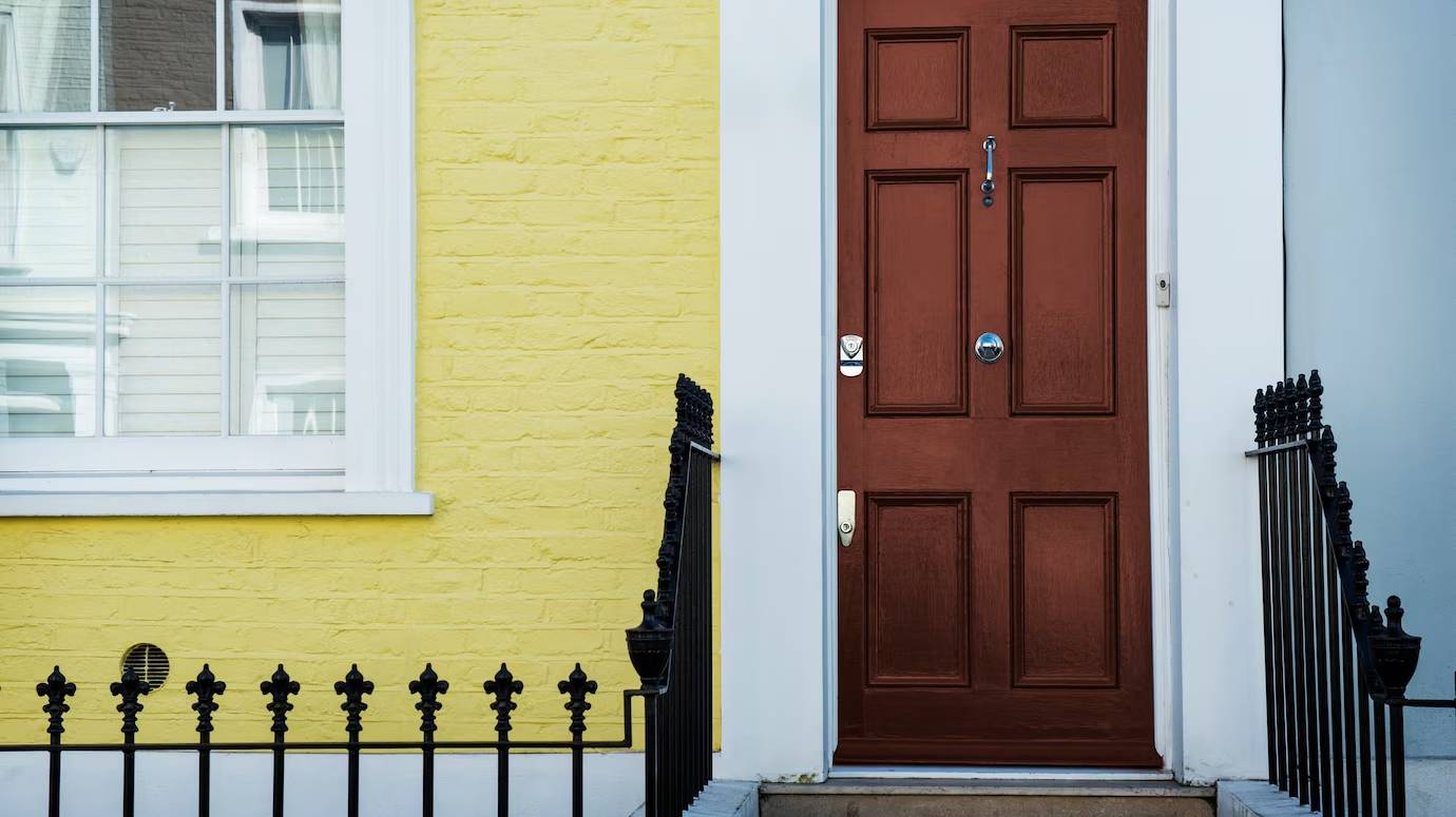 front-view-front-door-with-blue-yellow-wall_23-2149360639