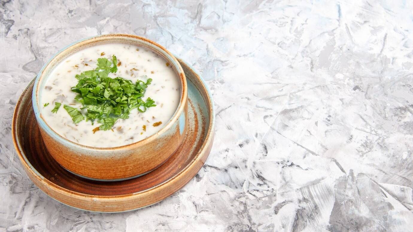 front-view-tasty-dovga-yogurt-soup-with-greens-white-table-soup-meal-dish_140725-125235