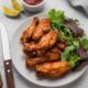high-angle-plate-with-fried-chicken-salad-with-sauce-cutlery_23-2148646615