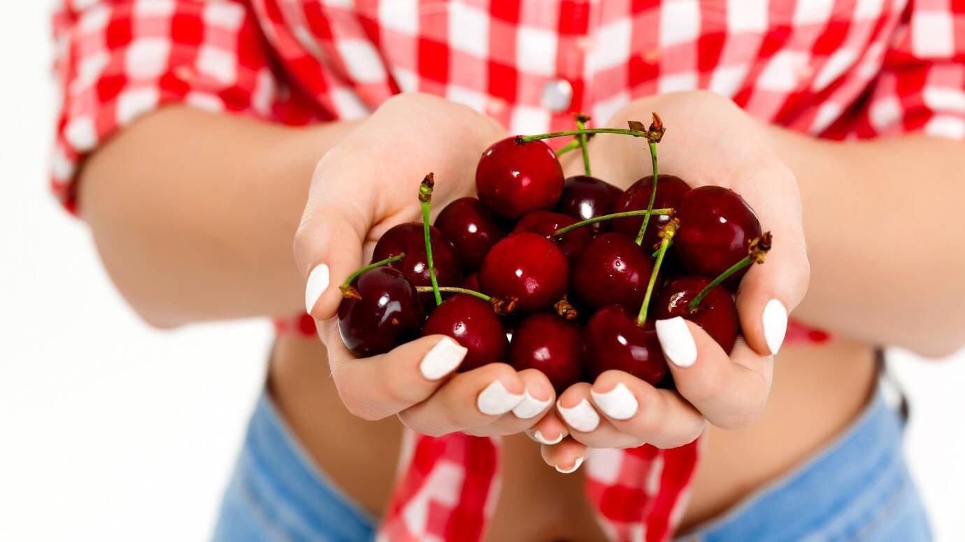 close-up-cherry-woman-s-hands_176420-4912