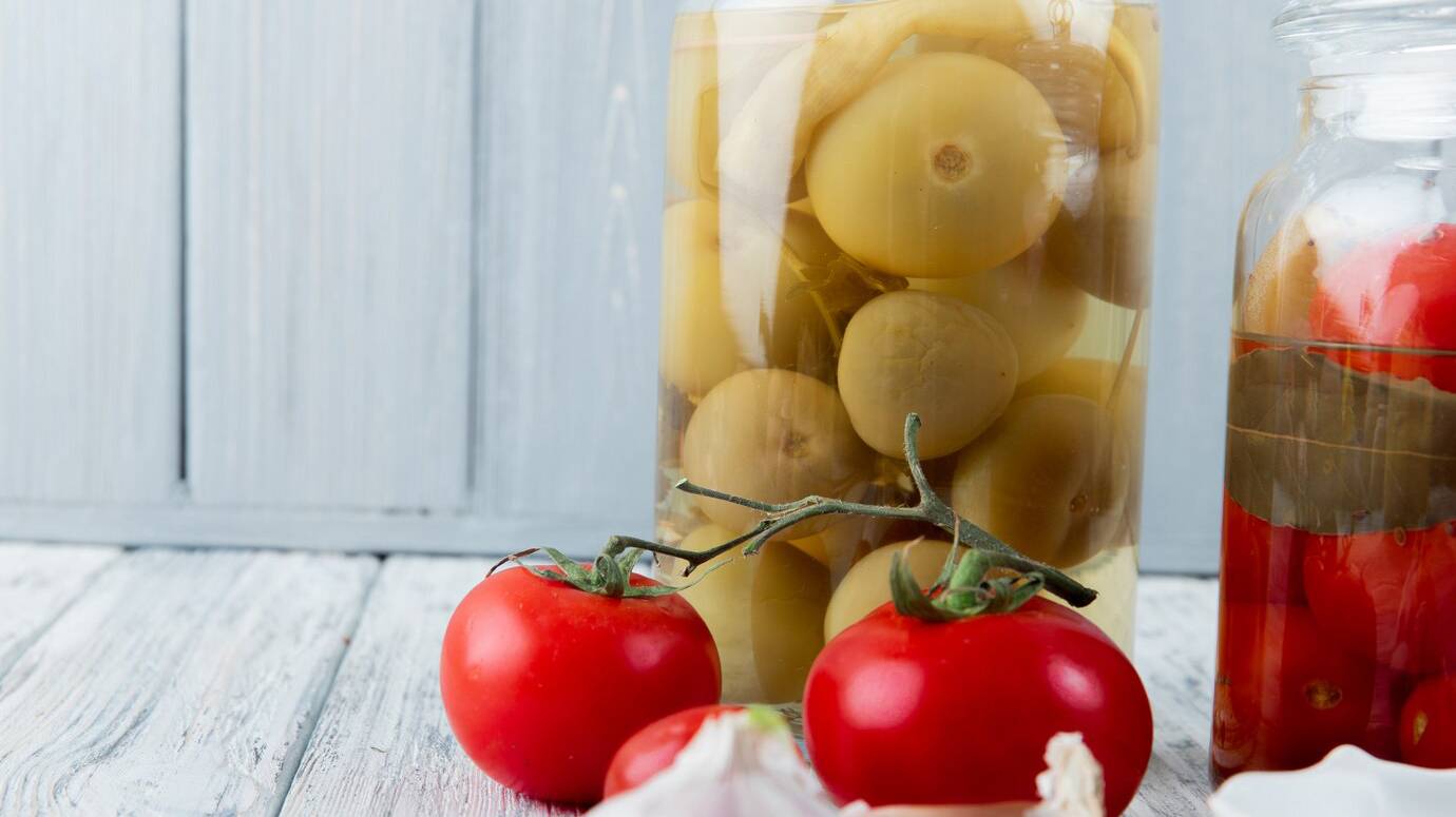close-up-view-sour-green-red-tomatoes-wooden-surface-background-with-copy-space_141793-5529