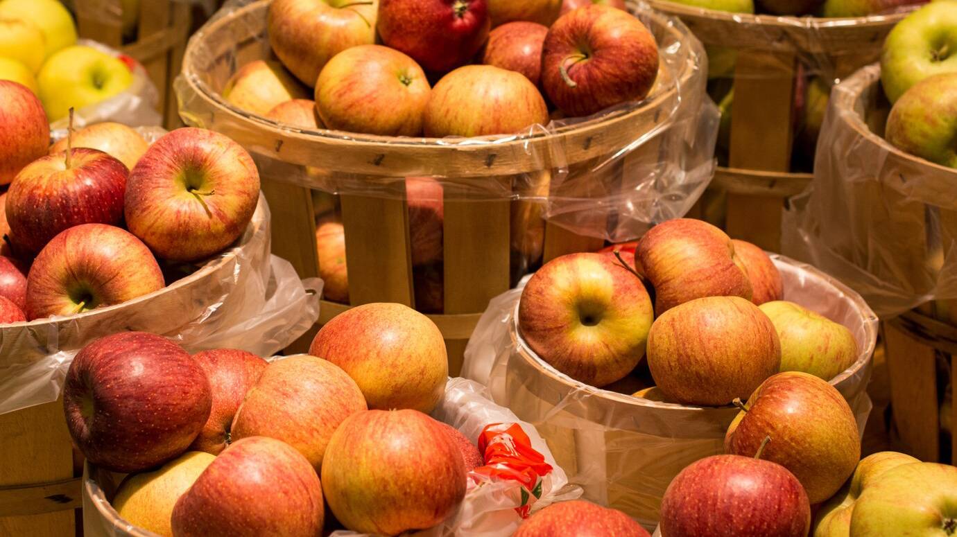apples-wooden-containers-lights_181624-8927