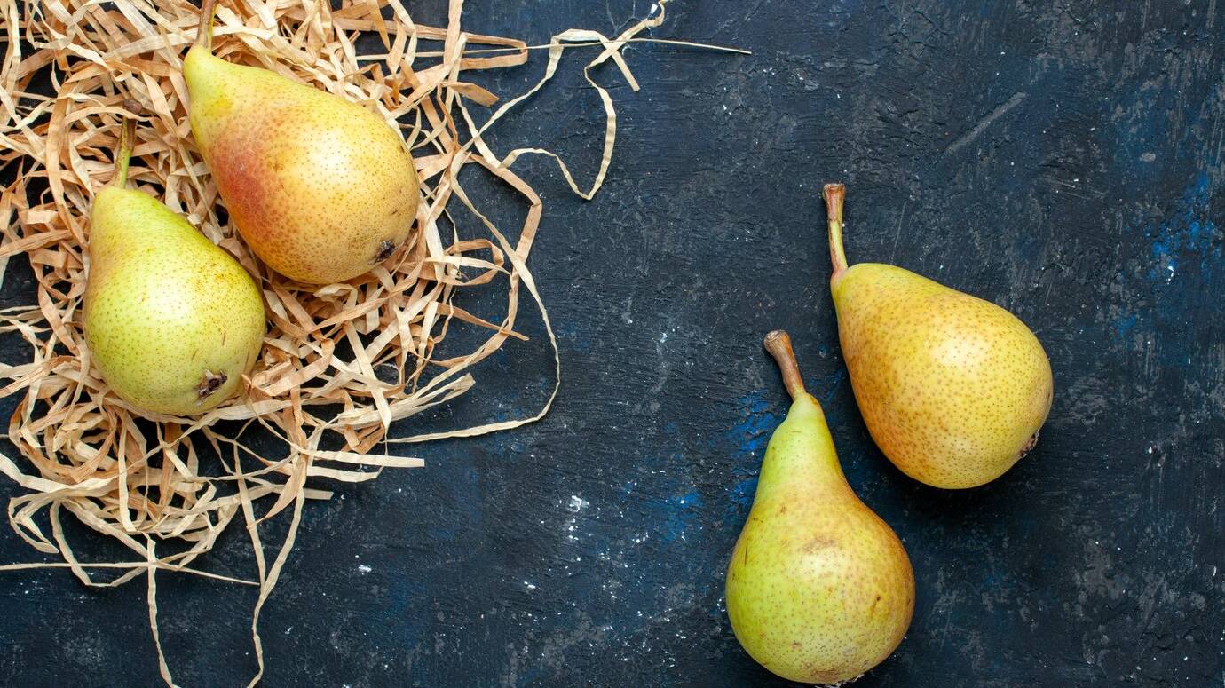 top-view-fresh-mellow-pears-whole-ripe-sweet-fruits-dark-grey-desk-fruit-mellow-food-health_140725-34345