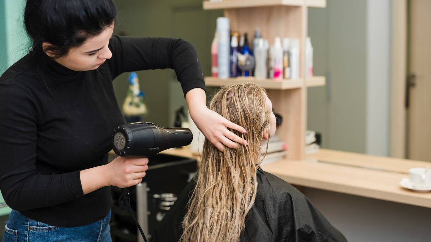 blonde-girl-getting-her-hair-dried_23-2148108830