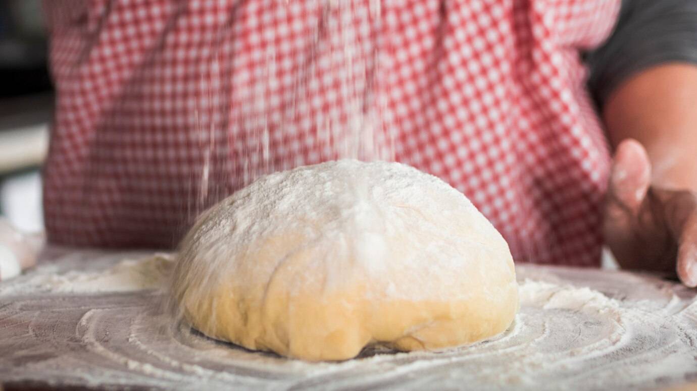 close-up-flour-falling-kneaded-dough_23-2147926000