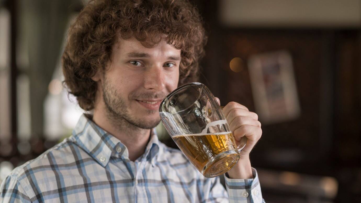 man-with-beer-looking-camera_23-2147896998