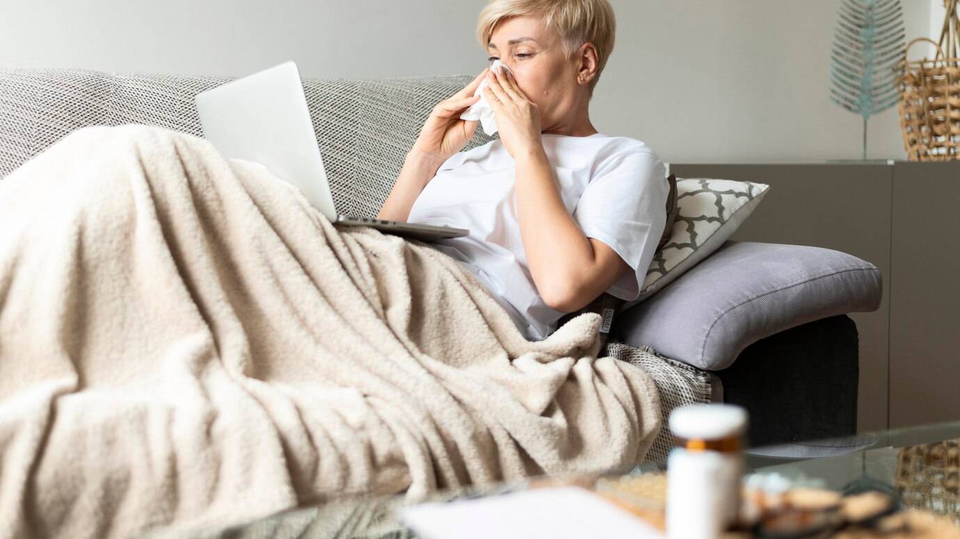 medium-shot-sick-woman-with-tissue_23-2148998321