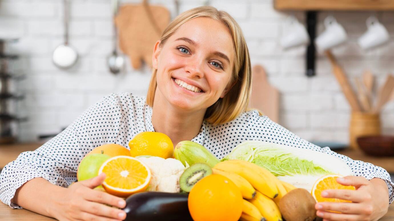 medium-shot-smiley-woman-with-delicious-fruits_23-2148302099