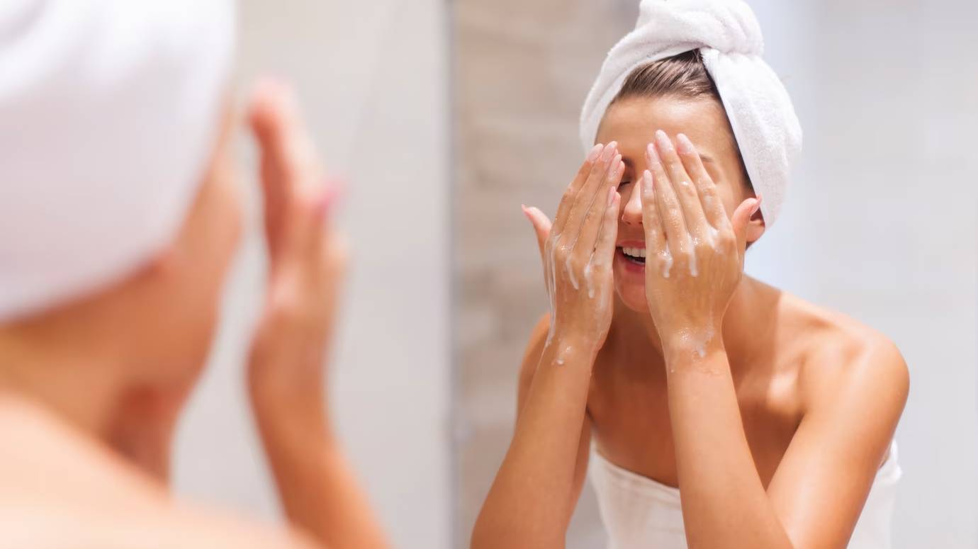 woman-washing-face-bathroom_329181-2386