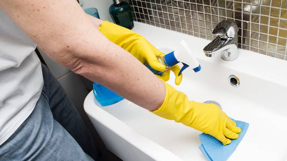 woman-with-rubber-gloves-cleaning-sink_23-2148465090