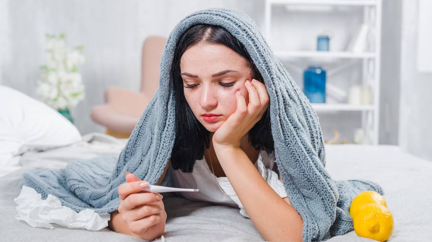 young-woman-with-scarf-around-her-head-checking-fever-with-thermometer_23-2147948552 young-woman-with-scarf-around-her-head-checking-fever-with-thermometer_23-2147948552