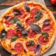 close-up-view-pizza-wooden-table_23-2148643427