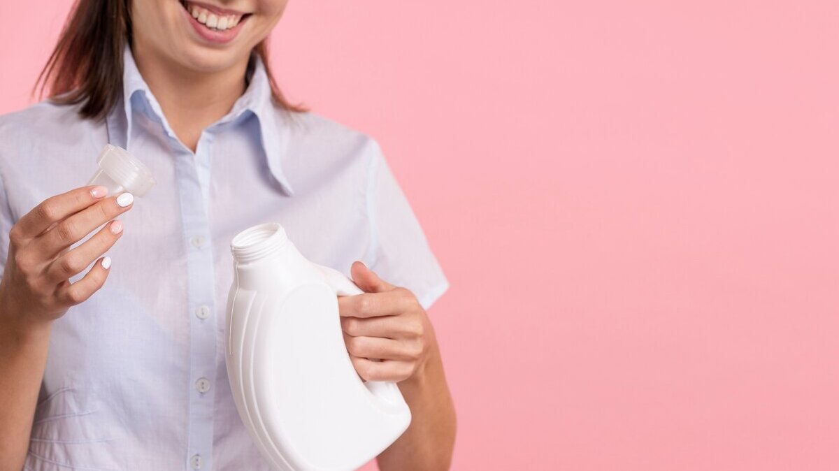 close-up-woman-holding-detergent-laundry-bottle_23-2148246456