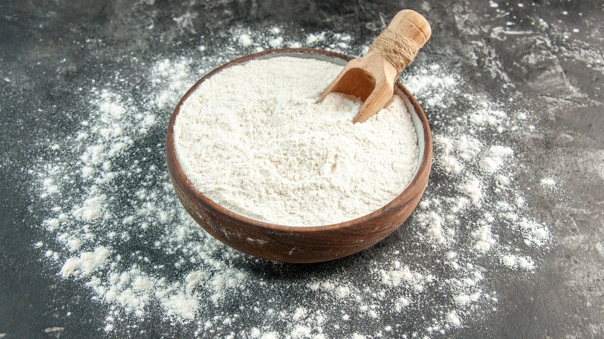 front-close-view-white-flour-with-wooden-spoon-inside-outside-brown-bowl-gray-background_140725-131041