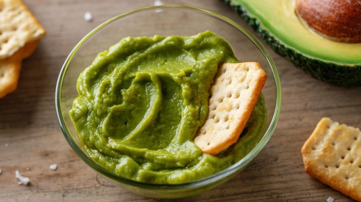 mashed-avocado-guacamole-sauce-bowl-with-crackers_1220-6993