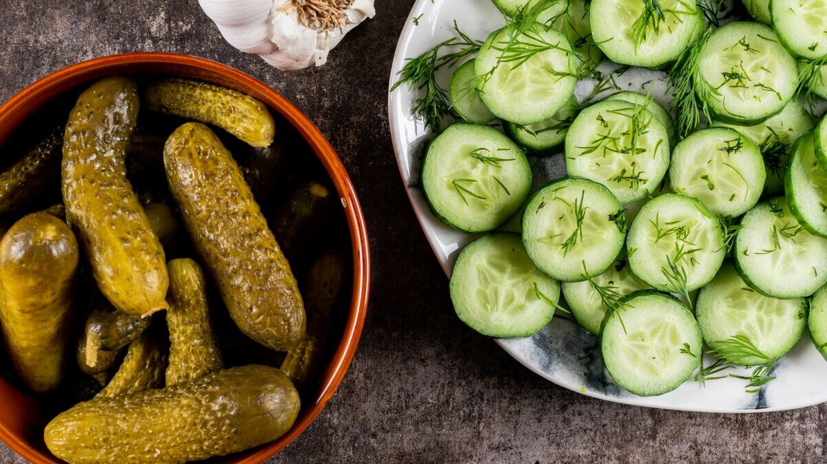 top-view-cucumber-fresh-sliced-with-dill-plate-pickled-bowl-brown-stone_176474-997