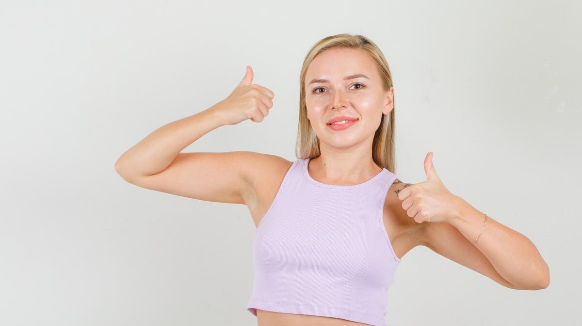 young-woman-showing-thumbs-up_176474-13100
